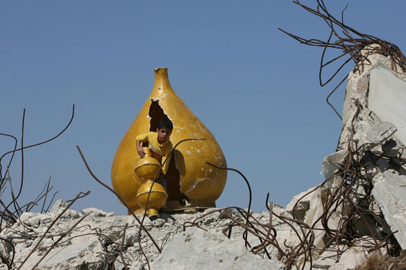 24 hours in pictures: A Palestinian child plays in the rubble of a mosque