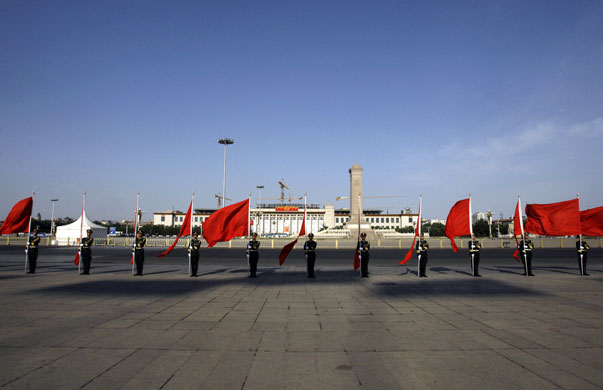 24 hours in pictures: Chinese guards stand in position against the backdrop of Tiananmen Square 