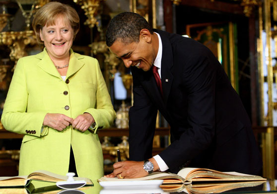 Obama in Germany: German Chancellor Angela Merkel and President Barack Obama sign a book 