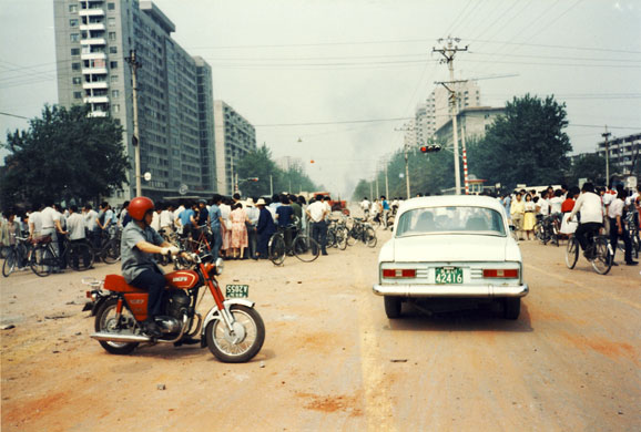 Tiananmen protests 1989: A crowd gathers around the human remains in front of PLA 301st Hospital