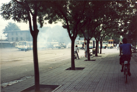 Tiananmen protests 1989: A tank pushes through a roadblock of buses set up by civilian protesters.