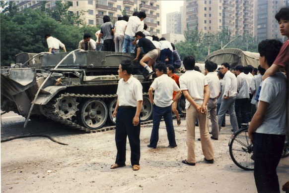 Tiananmen protests 1989: Civilians climb atop an armoured vehicle Fuxing Road, Beijing