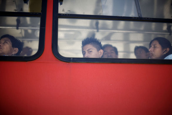 24 hours: Passengers travel in a public bus in Guatemala City