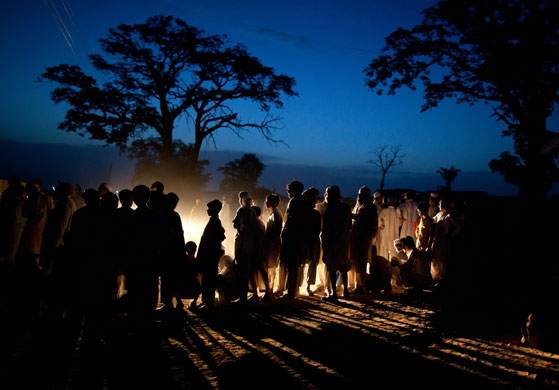 24 hours: Pakistani refugees wait in line to get bread at the Yar Hussain camp
