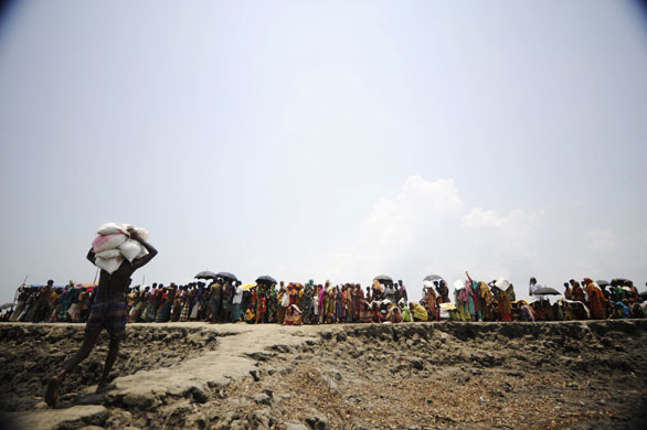 24 hours: Bangladeshi workers unload relief materials from a boat in Gabura