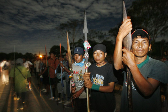 24 hours in pictures: Native people hold sticks as they barricade the entrance to Yurimagua city