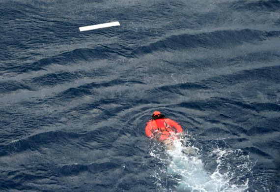 Search for Air France jet: A diver from French military vessel Ventose swims towards floating debris