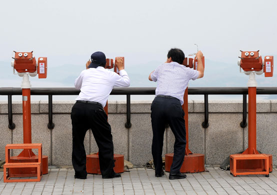 24 hours in pictures: Tourists look at the North Korean side from a South Korean observation post