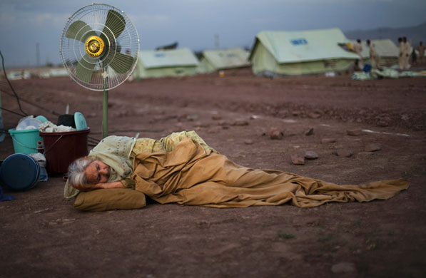 24 hours in pictures: Displaced Pakistani waits for a tent