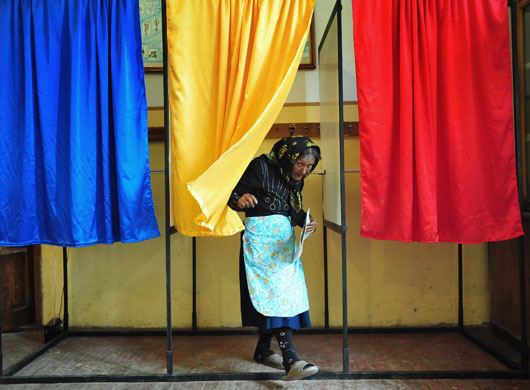 24 hours in pictures: An elderly Romanian woman leaves the voting cabin