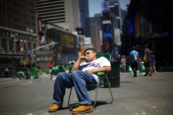 24 hours in pictures: A man sleeps in a chair along the closed portion of Broadway in New York