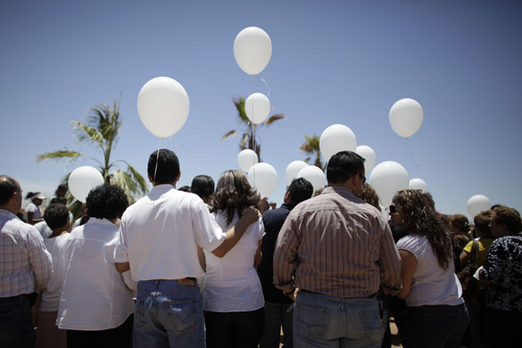 24 hours in pictures: Relatives of Monzerrat Granado Peres attend her burial