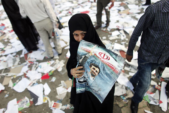 Iran elections: A supporter of Mahmoud Ahmadinejad at a pre-election gathering in Tehran 