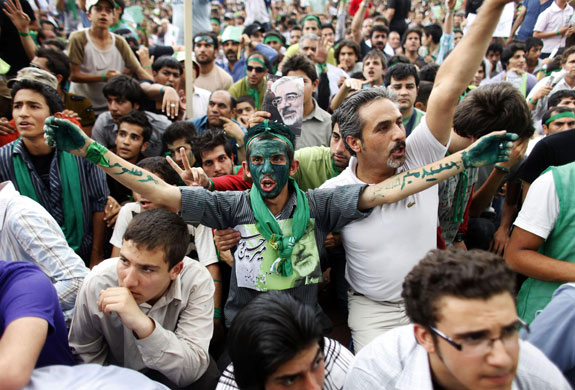 Iran elections: Supporters of Mir Hossein Mousavi react as he addresses a rally