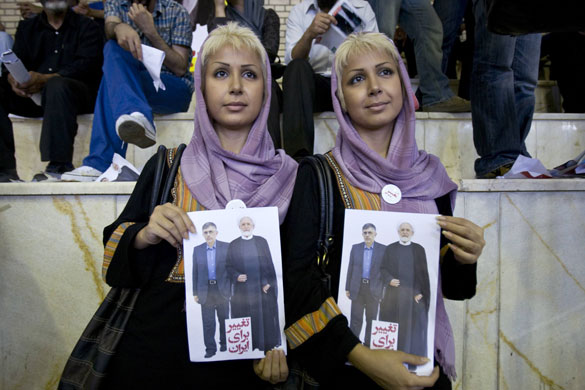 Iran elections: Identical twins hold posters of Mehdi Karroubi and Gholamhossein Karbaschi