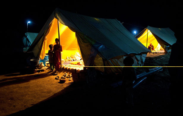 9 June 2009: Swabi, Pakistan: Children stand by their tent at Chota Lahore camp