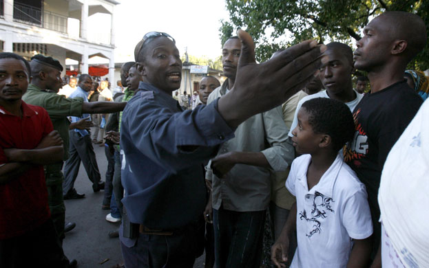 Yemenia Airways crash: A policeman maintains order among relatives of an Airbus A310-300