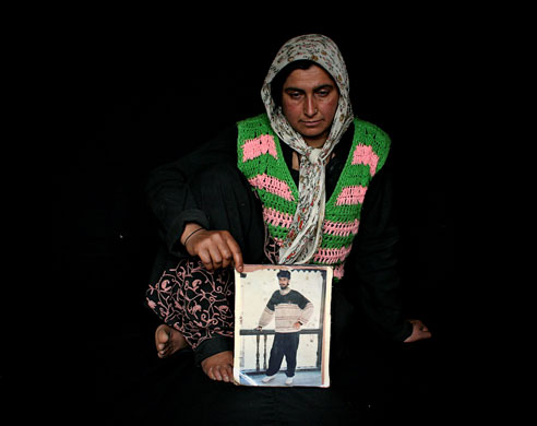 1 July 2009: Srinagar, India: Naseema holds a picture of her missing husband