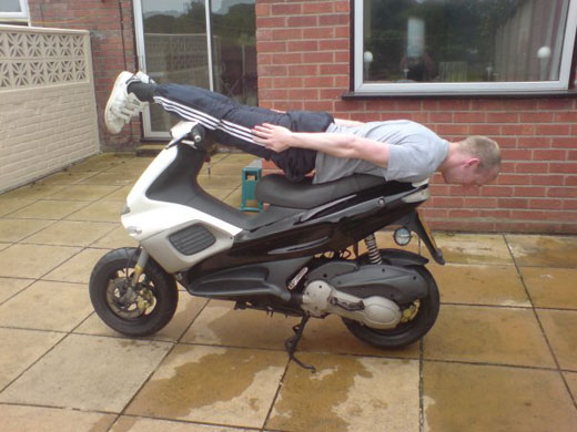 Facedown: Facebook lying down game on a motorbike