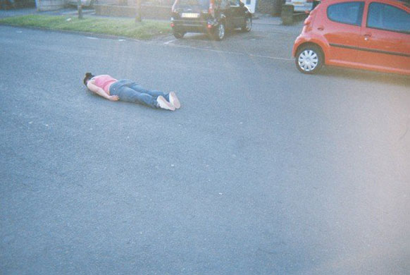 Facedown: Facebook lying down game on a road