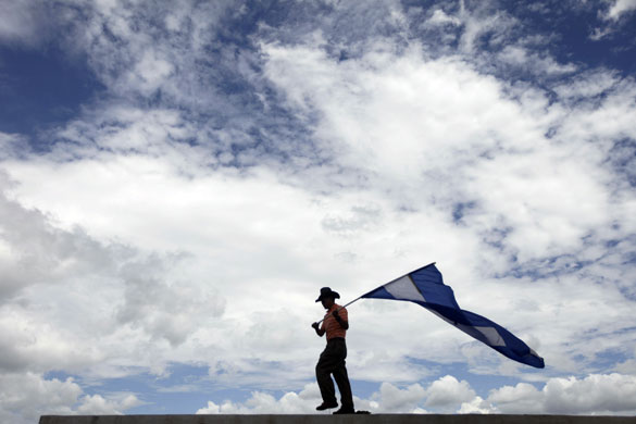 24 hours in pictures: A supporter of Honduras' ousted President 