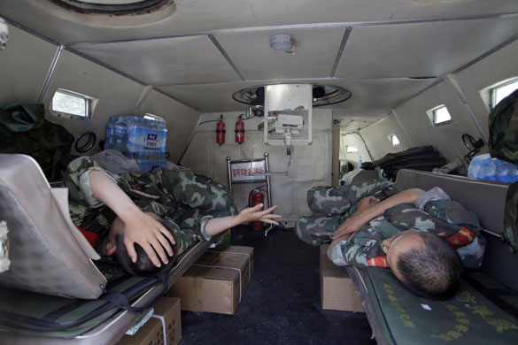 Dan Chung in Urumqi: Security forces rest in the back if an APC