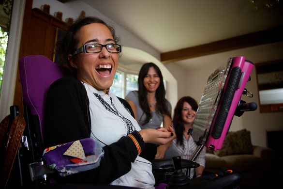 Nadia Clarke: A girl laughs with her Mum and careworker in background