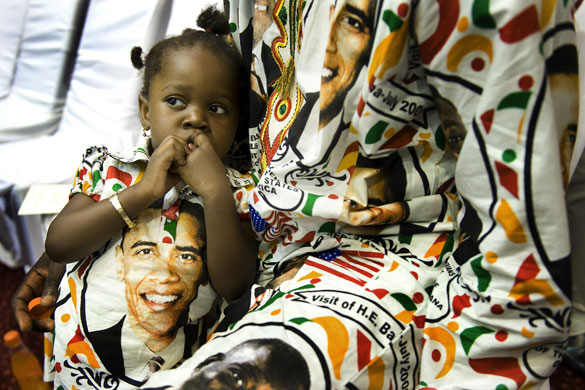 24hours in pictures: Girl sits as she waits for President Barack Obama's arrival in Ghana