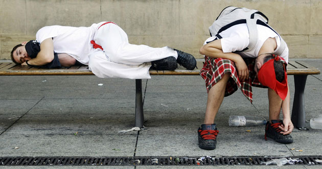 13 July 1009: : Pamplona, Spain: Revellers sleep on a public bench