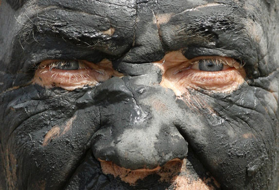 13 July 1009: : Krasnoyarsk, Russia: A man covered in mineral-rich black mud