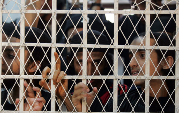 13 July 1009: : Sanaa, Yemen: Al-Qaeda militants listen to a verdict from behind bars