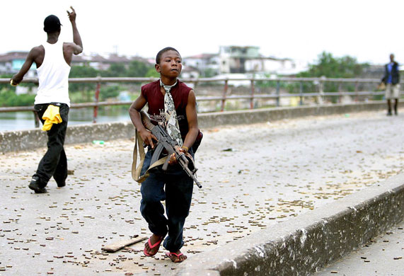 Charles Taylor: 2003: A Liberian child soldier fighting for Charles Taylor's forces
