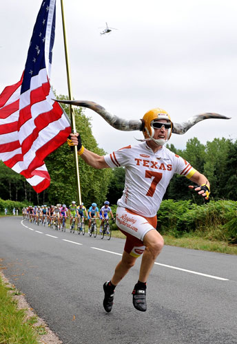 Tour de France Stage 10: A Lance Armstrong fan runs with the peloton
