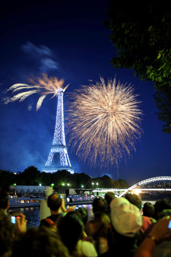 Bastille Day: People watch fireworks exploding over the Eiffel Tower