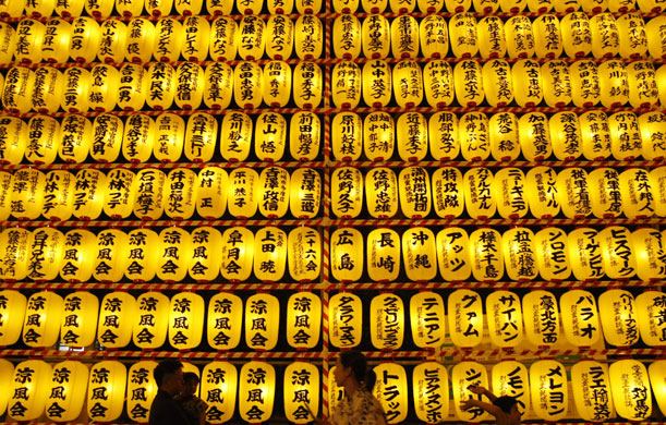 15 July 2009: Tokyo, Japan: Visitors walk past paper lanterns during the Mitama Festival