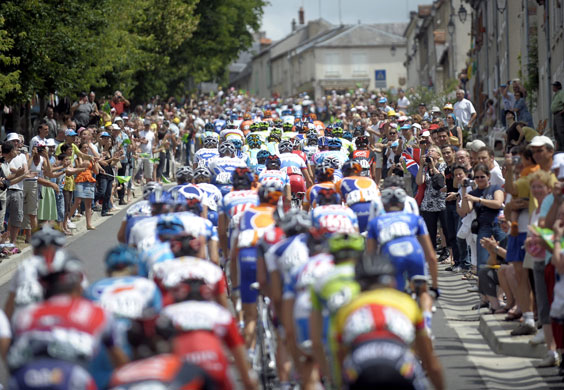 tour de france stage 11: Fans cheer as the peloton makes it's way into a village