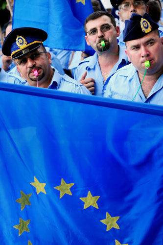 16 July 2009: Bucharest, Romania: Penitantiary system workers hold an EU flag