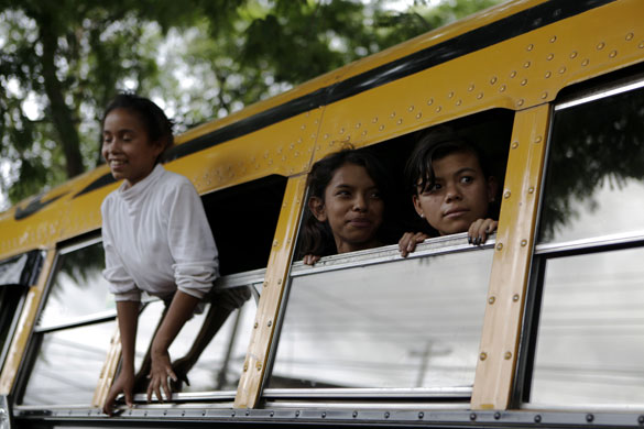 16 July 2009: Tegucigalpa, Costa Rica: Girls look out from a bus