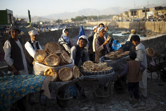 16 July 2009: Kabul, Afghanistan: Men wait for customers as they sell bread in a market