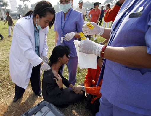 Jakarta bombings: A victim receives treatment outside the Ritz-Carlton hotel in Jakarta