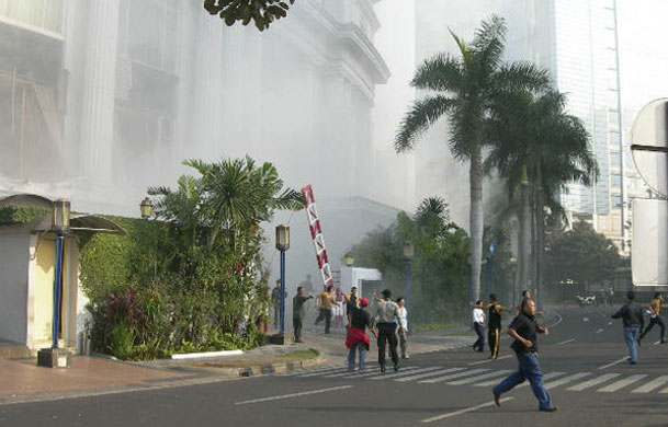 Jakarta bombings: People run following a blast at the Ritz-Carlton Hotel in Jakarta