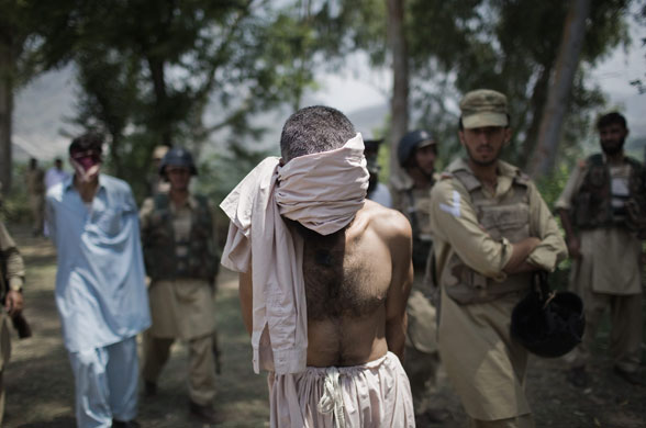 24 hours in pictures: Suspected Taliban militants are held by the Pakistan Military