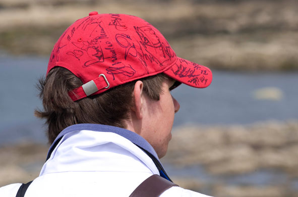 Open Golf Day 2: A scoreboard carrier has also been busy collecting autographs on his hat