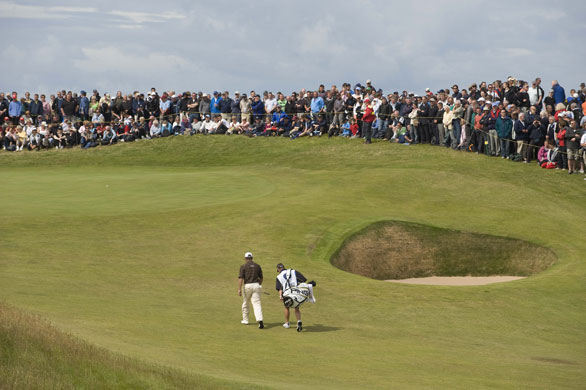Open Golf day 4: Lee Westwood and caddy stroll past a bunker towards the 6th green