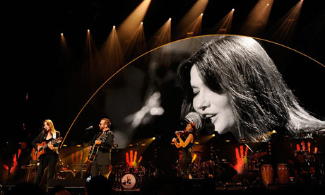 Carla Bruni-Sarkozy and musician Dave Stewart on stage at Mandela Day concert