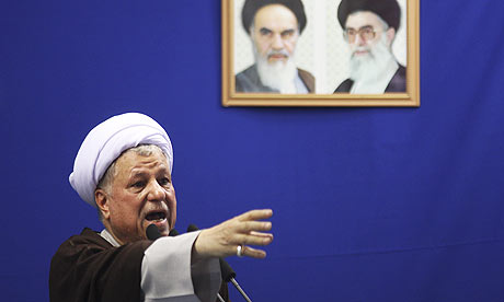 Hashemi Rafsanjani at Friday prayers under the pictures of Ayatollah Khomeini, left, and supreme leader Ayatollah Ali Khamenei. Photograph: Meisam Hosseini/AP