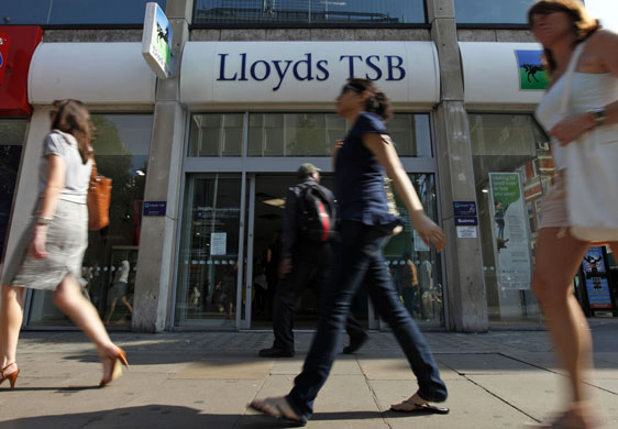 Week in Business: Pedestrians walk past a branch of Lloyds bank