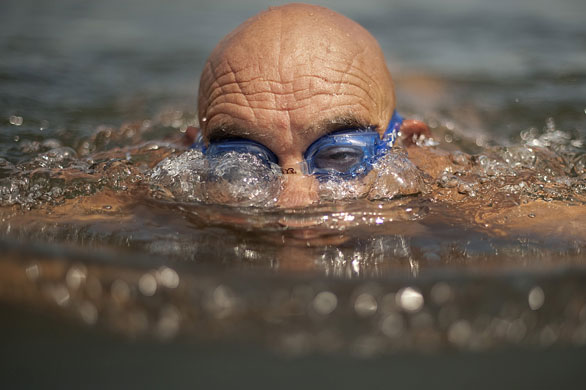 24hours in pictures: A man swims in the Serpentine Lido in central London