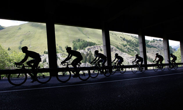 Tour de France stage 16: Riders cycle under a tunnel in the mountains