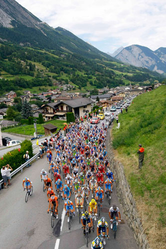 Tour de France stage 16: The peloton streams past a small Alpine village 